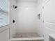Clean and bright shower with gray hexagon tile floor and white subway tile walls at 718 34Th S Ave, St Petersburg, FL 33705