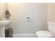 Clean and simple half bathroom with pedestal sink and toilet at 7236 Grand Elm Dr, Riverview, FL 33578