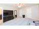 Main bedroom with large TV and walk-in closet at 7236 Grand Elm Dr, Riverview, FL 33578