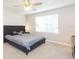 Main bedroom with king bed and ceiling fan at 7236 Grand Elm Dr, Riverview, FL 33578