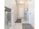 Bright and airy entryway with tile flooring, and access to a downstairs bedroom at 7236 Grand Elm Dr, Riverview, FL 33578