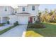 Two-story townhome with a two-car garage and well-manicured lawn at 7236 Grand Elm Dr, Riverview, FL 33578