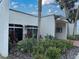 White building exterior with lush landscaping and palm trees at 7701 Starkey Rd # 710, Seminole, FL 33777