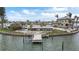 Waterfront view featuring a private boat dock and lush landscaping in a serene setting at 7800 3Rd S Ave, St Petersburg, FL 33707