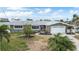 Charming single-story home with a well-maintained lawn, mature trees, and a two-car garage at 7800 3Rd S Ave, St Petersburg, FL 33707
