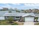 House exterior showcasing a gray facade, white garage door, and landscaping at 7800 3Rd S Ave, St Petersburg, FL 33707