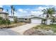 Charming single-story home with a well-maintained lawn, mature trees, and a two-car garage at 7800 3Rd S Ave, St Petersburg, FL 33707