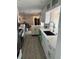 Modern kitchen with stainless steel appliances, white cabinetry, and eat-in dining space at 7800 3Rd S Ave, St Petersburg, FL 33707