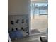 View of a pool and the canal through a sliding glass door in disrepair at 7800 3Rd S Ave, St Petersburg, FL 33707