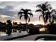 Scenic waterfront view at sunset, featuring palm trees and the soft glow of twilight reflecting on the water at 7800 3Rd S Ave, St Petersburg, FL 33707