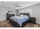 Main bedroom with king-size bed, updated flooring and ceiling fan at 8334 139Th Ln, Seminole, FL 33776