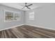 Well-lit bedroom with wood-look floors and window shutters at 8334 139Th Ln, Seminole, FL 33776