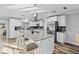 Modern kitchen with white cabinets, granite island, and stainless steel appliances at 8334 139Th Ln, Seminole, FL 33776