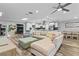 Open concept living room with sectional sofa, large TV, and hardwood floors at 8334 139Th Ln, Seminole, FL 33776