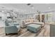 Spacious living room with L-shaped sofa and large windows at 8334 139Th Ln, Seminole, FL 33776
