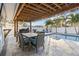 Outdoor patio with pool, table, chairs, and grill at 8334 139Th Ln, Seminole, FL 33776