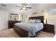 Main bedroom with king bed, wood furniture, and tile floors at 11245 Bella Loma Dr, Largo, FL 33774