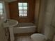 Small bathroom with a tub, toilet, and pedestal sink at 1209 E Dr Martin Luther King Jr Blvd, Tampa, FL 33603
