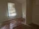 Small bedroom with wood floors and window at 1209 E Dr Martin Luther King Jr Blvd, Tampa, FL 33603