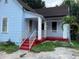 Front view of a light blue house with a red porch and white railings at 1209 E Dr Martin Luther King Jr Blvd, Tampa, FL 33603