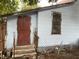 Side of house with red door and steps, showing some landscaping at 1209 E Dr Martin Luther King Jr Blvd, Tampa, FL 33603