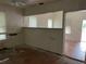 Simple living room with hardwood floors and a partial wall at 1209 E Dr Martin Luther King Jr Blvd, Tampa, FL 33603