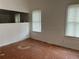 Living room with wood floors and two windows at 1209 E Dr Martin Luther King Jr Blvd, Tampa, FL 33603