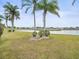 Backyard view of a pond, landscaping and homes at 1209 Peridot Ln, Sun City Center, FL 33573