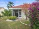Backyard with a screened patio and lush landscaping at 1209 Peridot Ln, Sun City Center, FL 33573