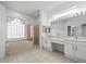 Bathroom with double vanity and bathtub at 1209 Peridot Ln, Sun City Center, FL 33573