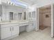 Double vanity bathroom with a large closet at 1209 Peridot Ln, Sun City Center, FL 33573