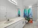 Bathroom with a shower/tub combo and colorful shower curtain at 1209 Peridot Ln, Sun City Center, FL 33573
