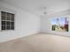 Bedroom with window and ceiling fan at 1209 Peridot Ln, Sun City Center, FL 33573
