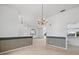 Spacious dining room with a chandelier and striped wallpaper at 1209 Peridot Ln, Sun City Center, FL 33573