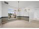 Dining room with carpeting, a chandelier, and striped wallpaper at 1209 Peridot Ln, Sun City Center, FL 33573