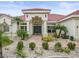 White two-story house with red tile roof, landscaping, and a paved walkway at 1209 Peridot Ln, Sun City Center, FL 33573