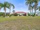 Back view of single-story home with lush landscaping at 1209 Peridot Ln, Sun City Center, FL 33573