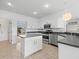 Island kitchen with stainless steel appliances at 1209 Peridot Ln, Sun City Center, FL 33573