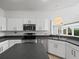Kitchen features stainless steel appliances and ample counter space at 1209 Peridot Ln, Sun City Center, FL 33573