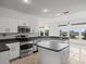 Spacious kitchen with stainless steel appliances and island at 1209 Peridot Ln, Sun City Center, FL 33573