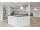 Modern kitchen with white cabinets and breakfast bar at 1209 Peridot Ln, Sun City Center, FL 33573