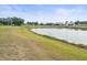 Scenic view of lake and homes in a tranquil community at 1209 Peridot Ln, Sun City Center, FL 33573