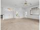 Large living room featuring carpet and mirror at 1209 Peridot Ln, Sun City Center, FL 33573