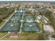 Aerial view of multiple tennis courts in a community at 1209 Peridot Ln, Sun City Center, FL 33573