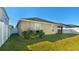 Backyard view of a home with grassy area and AC unit at 12410 Ballentrae Forest Dr, Riverview, FL 33579