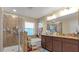Bathroom with shower, tub, granite vanity, and ample storage at 12410 Ballentrae Forest Dr, Riverview, FL 33579