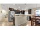 Modern kitchen with dark cabinetry, stainless steel appliances, and granite countertops at 12410 Ballentrae Forest Dr, Riverview, FL 33579