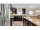 Kitchen boasts dark wood cabinets, granite counters, and stainless steel appliances at 12410 Ballentrae Forest Dr, Riverview, FL 33579