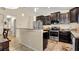 Open kitchen with island, stainless steel appliances, and dark wood cabinets at 12410 Ballentrae Forest Dr, Riverview, FL 33579