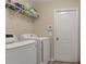 Laundry room with washer, dryer, and shelving for storage at 12410 Ballentrae Forest Dr, Riverview, FL 33579